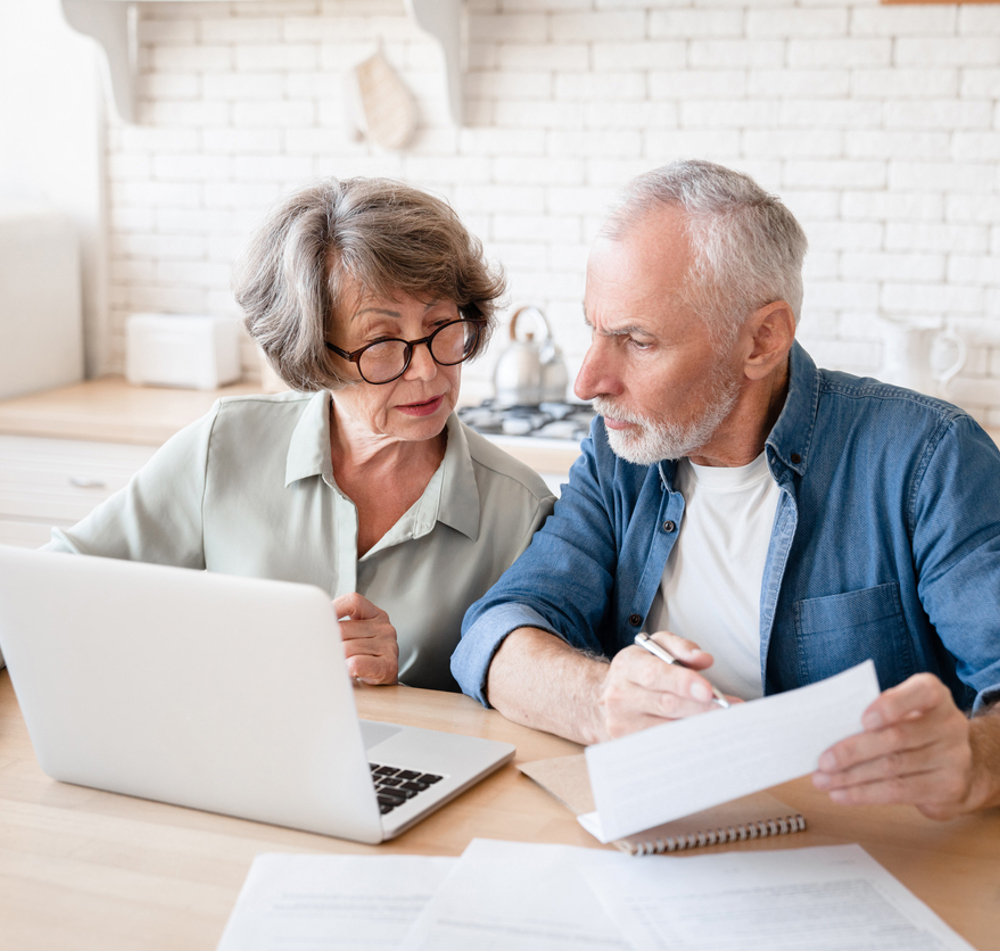 Man And Woman Looking At Paperwork