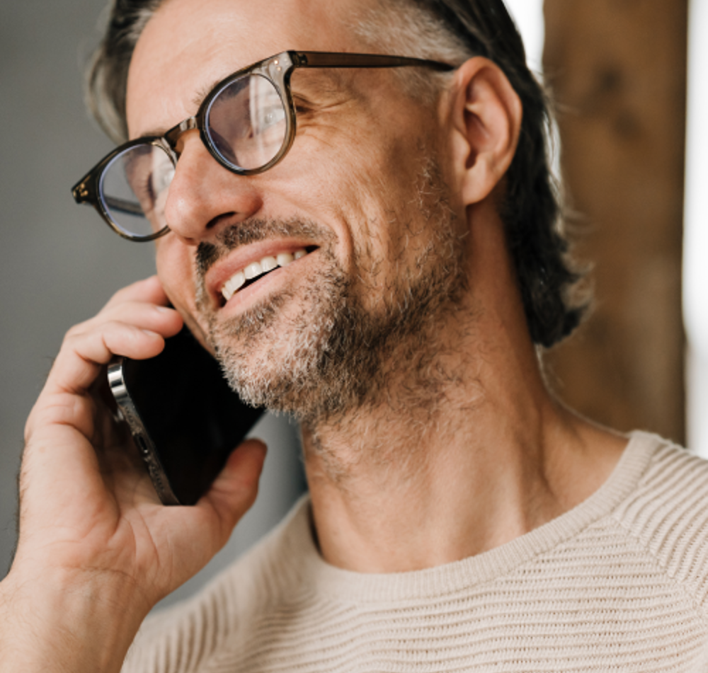 Man Smiling Holding Phone To Ear